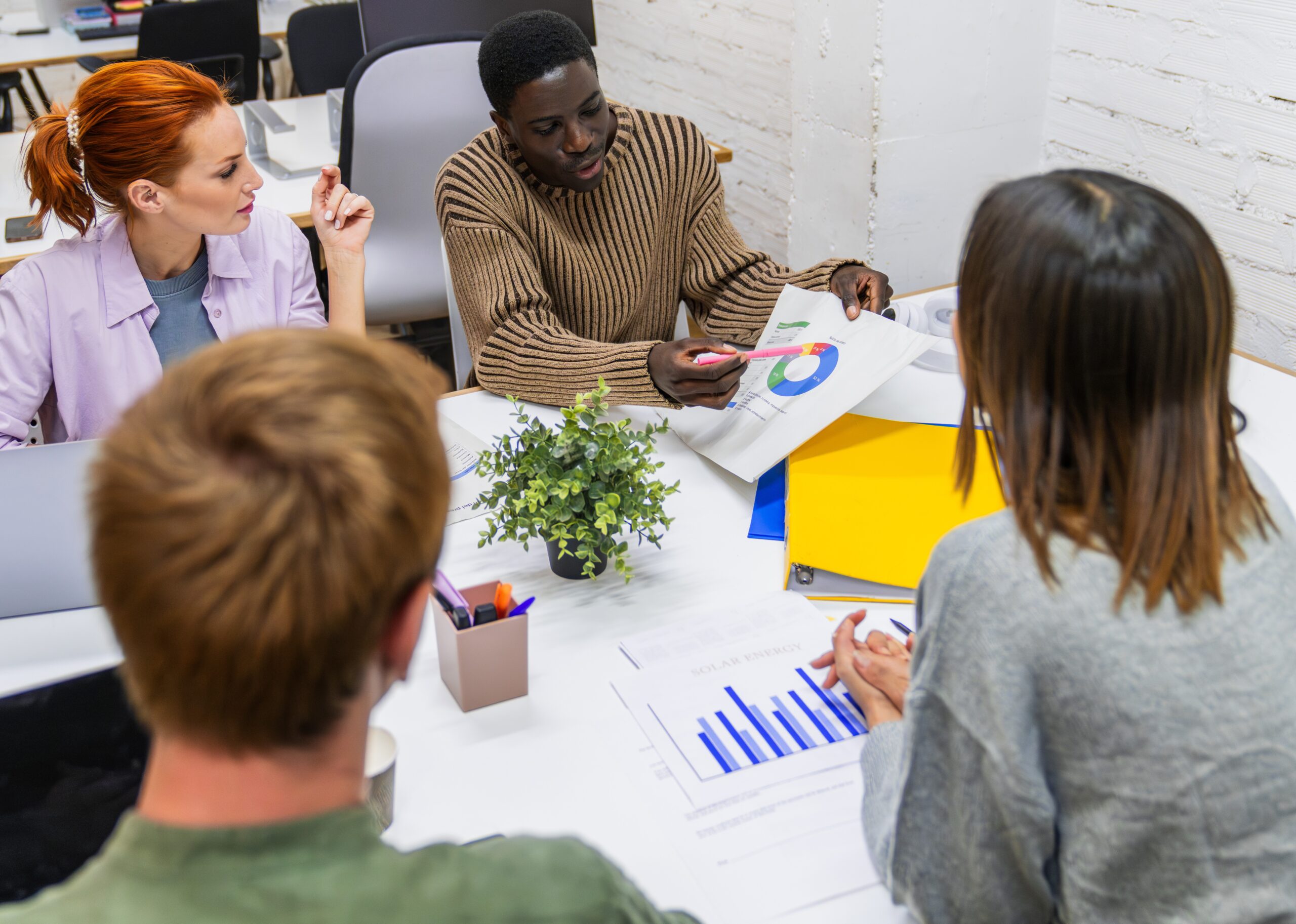 Marketing professionals discussing growth strategies in coworking space